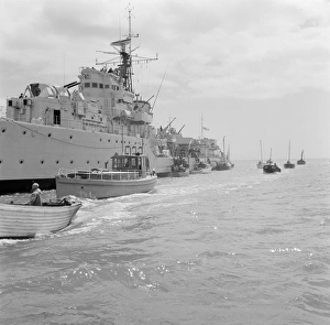A Royal Navy ship and small boats